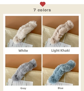 Detail showing soft plush hair claw clips in white, khaki, gray and blue colors