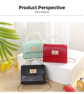 Detailed view of mini faux-crocodile skin bags with pearl handles and gold chain straps