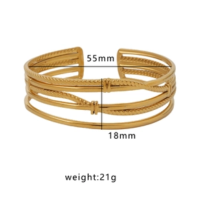 Adjustable 18k gold plated stainless steel cuff bracelet with woven texture on white background