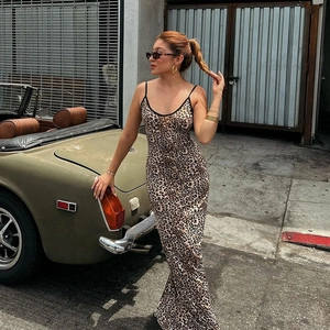 Outdoor street shot of a slim leopard print slip dress against a vintage sports car backdrop