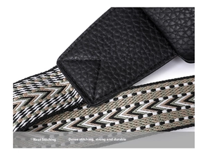 Detail of cross-body bag strap with lychee grain leather and geometric woven pattern