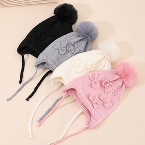 Winter knit earflap hats for toddlers with bow detail and pom poms in four colors