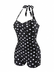 Detail of vintage polka dot halter one-piece swimsuit with ruched slimming tummy control