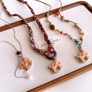 Handmade woven rocking horse pendant necklace with vintage ethnic beads and fabric chain