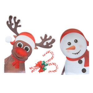Detail of Christmas magnets with reindeer, snowman, and candy cane in honeycomb texture