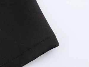 Detailed macro view of black fabric texture and high-quality stitching on the trench coat
