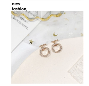 Macro shot of rose gold hoop earrings with micro-pave zircons and T-bar detail