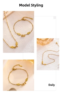 Close-up of golden fish pendant and beaded chain necklace with elegant metallic finish