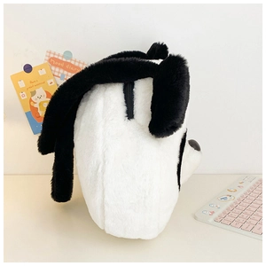 Close-up of fluffy black and white plush dog bag with zipper detail and soft texture