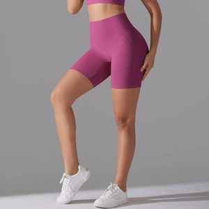 Close-up of high-waist magenta yoga biker shorts with ergonomic side stitching details