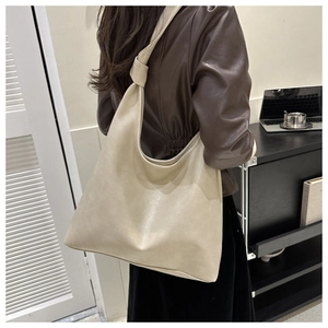 Lifestyle shot of a beige minimalist large capacity PU leather hobo shoulder bag
