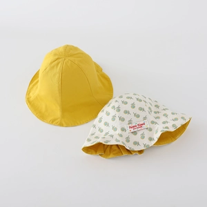 Detail view of yellow baby sun hat and floral print cotton reversible bucket hat