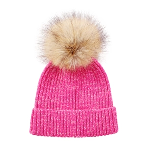 Close-up of rose pink ribbed knit beanie with a fluffy brown faux fur pom-pom detail