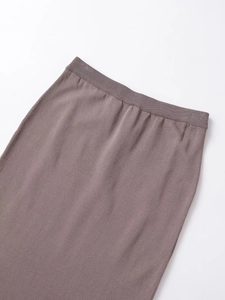 Detail of soft elastic waistband on brown knit straight skirt for women