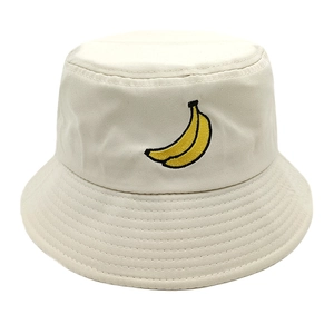 Close-up of yellow banana embroidery and detailed stitching on beige cotton bucket hat