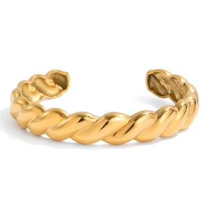Detail of twisted 18K gold-plated stainless steel cuff bracelet with high polish finish