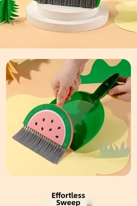 Detail shot of mini watermelon-shaped broom and dustpan set for desktop cleaning