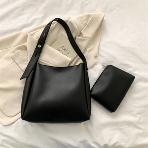 Detailed top view of minimalist black leather tote bag set with matching small zipper pouch