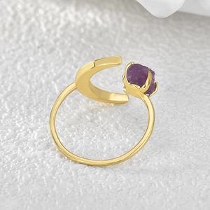 Adjustable gold crescent moon ring featuring a raw purple amethyst stone centerpiece