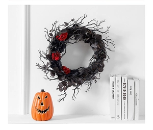 Macro shot of Halloween wreath with black withered branches and dark red roses