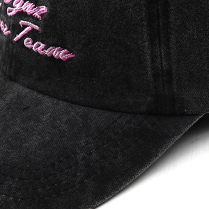 Close-up of vintage washed grey cotton baseball cap with pink Youth Team embroidery