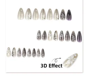 Detail of 3D effect press-on nails with grey gradient, white flowers and silver stars