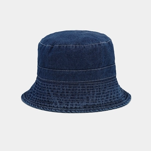Detailed view of reinforced stitching and washed denim texture on navy fisherman hat