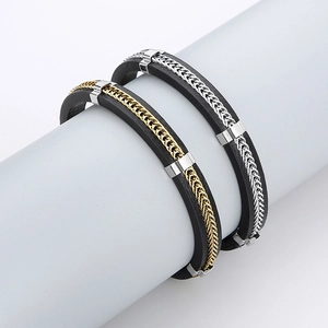 Detailed close-up of men's leather bracelets with woven gold and silver metal chains