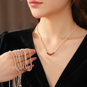 Elegant gold zircon round pendant necklace with red gemstones in a layered style