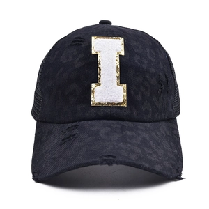 Detail of black leopard print baseball cap with chenille letter I and glitter embroidery