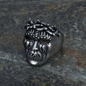 Punk style stainless steel skull ring with vintage silver mask design on dark rock