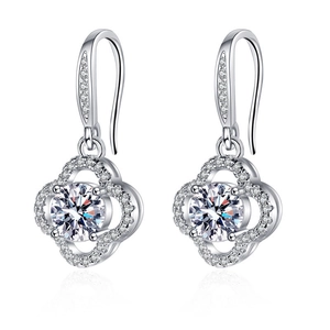 Detailed view of clover-shaped silver earrings with sparkling round zircon insets