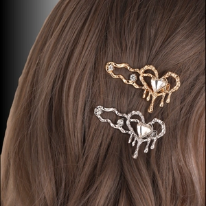 Golden and silver heart-shaped hair clips with melting drop design and rhinestones