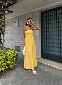 Detailed texture of yellow strapless maxi dress featuring honeycomb knit fabric