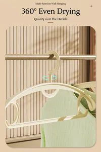 Detail view of the 360-degree rotating hook and non-slip shoulder on the beige hanger