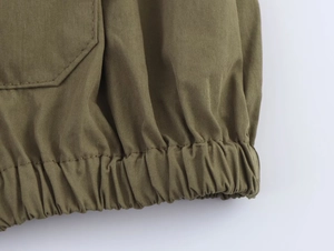 Detailed view of cargo set drawstring hem and precise stitching on army green twill fabric