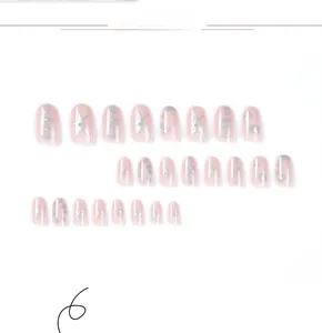 Detail view of oval press-on nails featuring silver stars and soft blue ink smudges