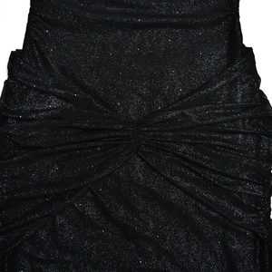 Close-up detail of black sequined evening dress featuring elegant waist pleats and shimmer