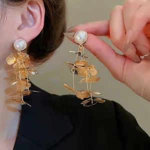 Elegant gold metal hollow petal tassel earrings with white pearls for women's jewelry