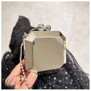 Close-up of octagonal silver mirror clutch bag with beaded chain and ball clasp