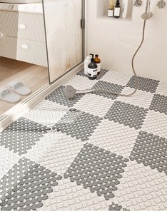 Close-up of interlocking TPE bathroom floor tiles with a grey and white checkerboard pattern