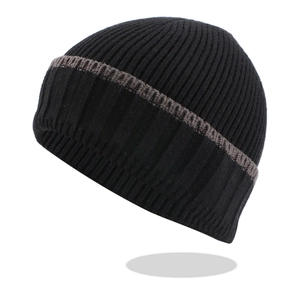 Detail of black ribbed knit beanie with brown stripes and thick warm texture