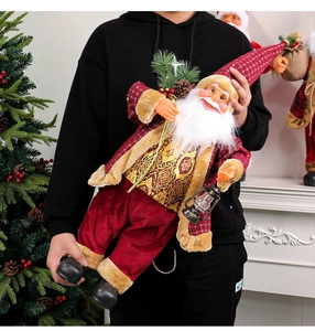 Detail of 24-inch Santa doll with red velvet suit, gold trim and festive lamp