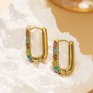 Macro detail of 18k gold plated rectangular earrings with multi-colored crystals on stones