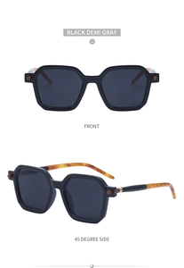 Detail view of black square sunglasses with tortoiseshell accents on temple arms