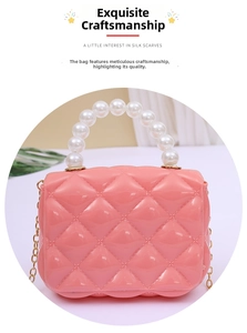 Close-up of pink jelly mini bag with diamond quilted texture and pearl bead handle