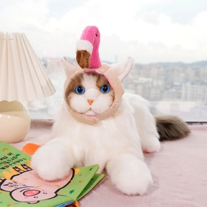 Detailed view of plush cat model wearing a pink flamingo knitted hat for pets