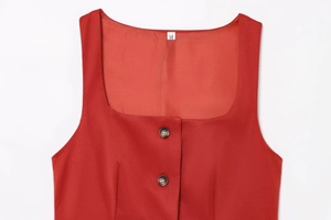 Detail shot of red vest showing fabric texture, M size label and black buttons