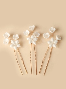 Set of three bridal hair pins featuring white ceramic flowers and crystal accents
