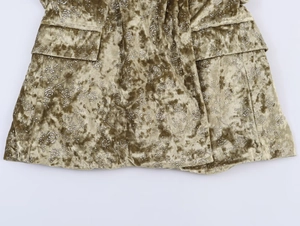 Detail of bronze velvet fabric with metallic floral print and high-quality stitching